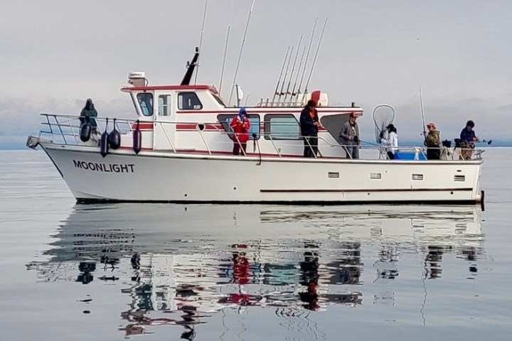 a group of people in a boat on a body of water